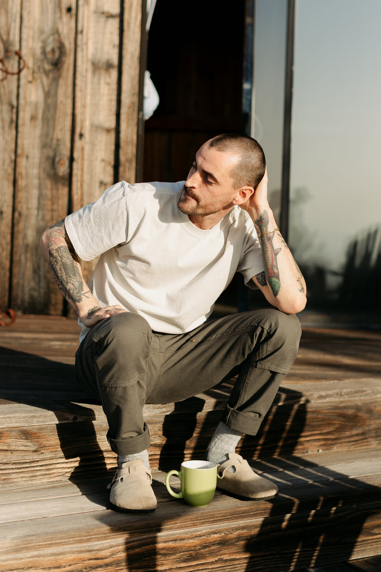 Men’s Draftsman Pant in Vintage Coal, featuring salt-washed cotton canvas and reinforced double-front panels, styled for a relaxed morning outdoors.