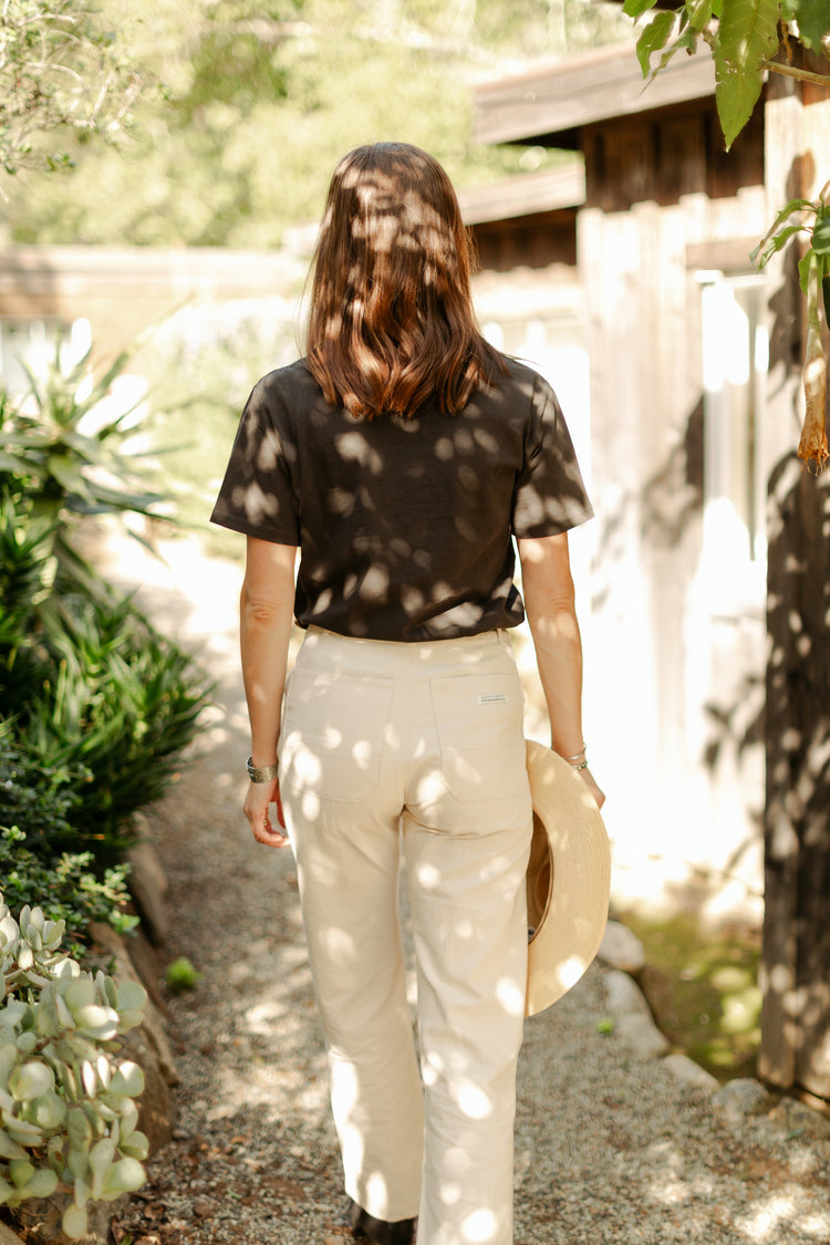 Back view of the high-waisted Lily Pant in softwashed cream, showcasing the straight-leg silhouette and durable 100% cotton canvas construction.