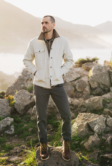 Men’s cream canvas rancher jacket styled with the Tradesman Pant in salt washed coal and leather work boots for a rugged outdoor look.