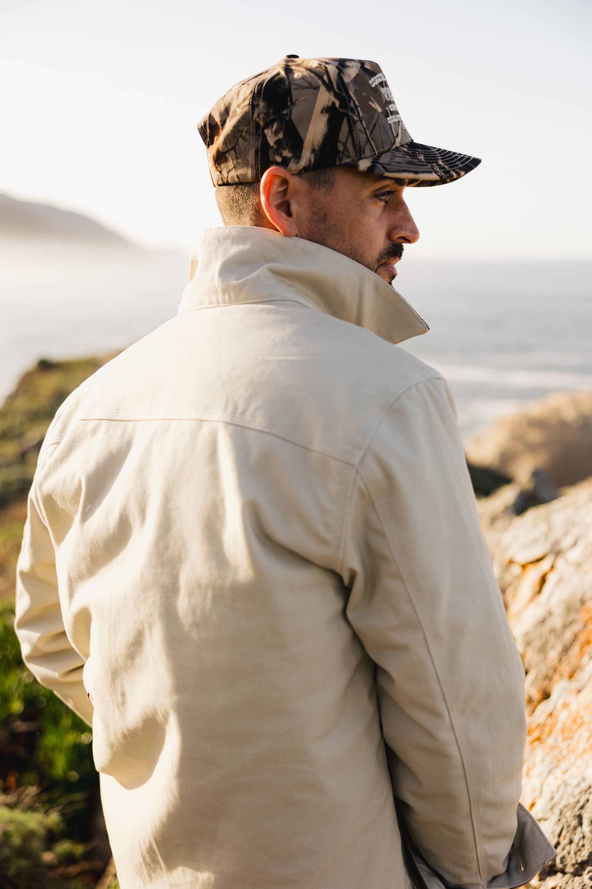 Back view of the cream Rancher jacket featuring heavy-duty triple-needle stitching and a reinforced shoulder yoke for maximum durability.