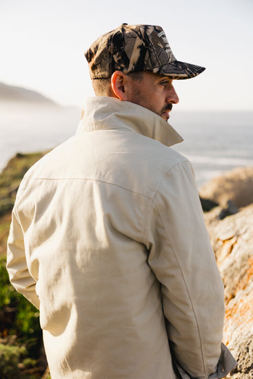 Back view of the cream Rancher jacket featuring heavy-duty triple-needle stitching and a reinforced shoulder yoke for maximum durability.