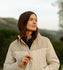 Close-up of a women's two-tone Cruiser Jacket in cream and tan, featuring a stand-up collar, diamond quilting, and a heavy-duty front zipper.