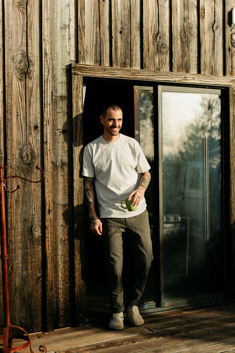 Men’s Draftsman Pant in Vintage Coal, featuring a salt-washed 100% cotton canvas and double-front utility panels, styled for a relaxed outdoor lifestyle.