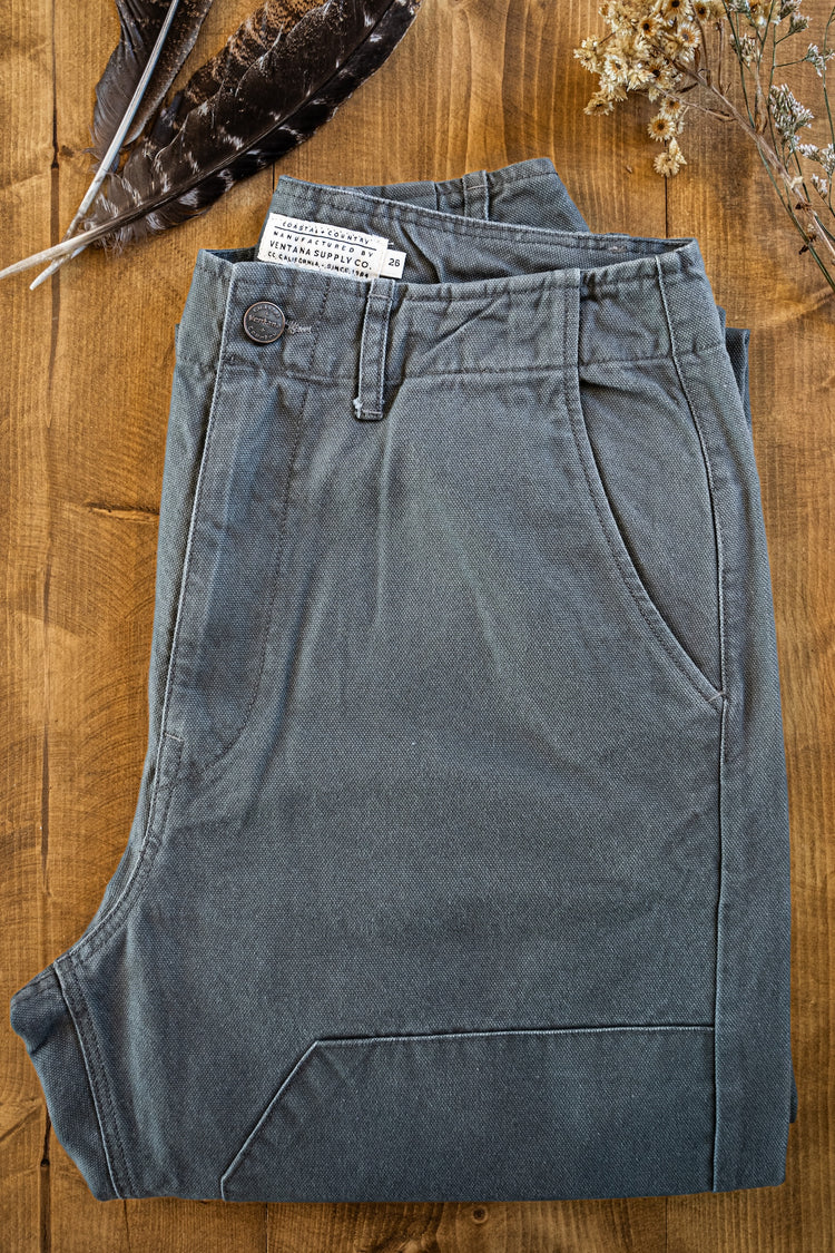 Alt Text: Close-up of the Draftsman Pant by Ventana Supply Co. in Vintage Coal, featuring a salt-washed cotton canvas finish, branded metal button, and double-front reinforcement stitching.