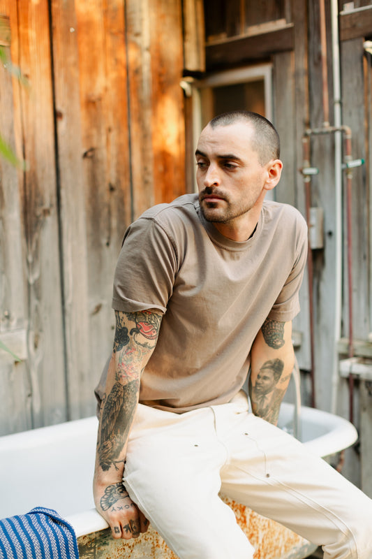 Men’s Draftsman Pant in soft washed cream, featuring triple-needle stitching and double-front reinforcement with copper rivets for maximum durability.