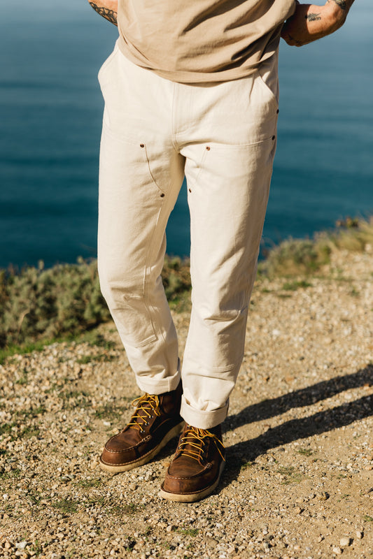 Men’s Draftsman Pant in soft washed cream, featuring a 100% cotton double-front construction with reinforced copper rivets for heavy-duty durability.