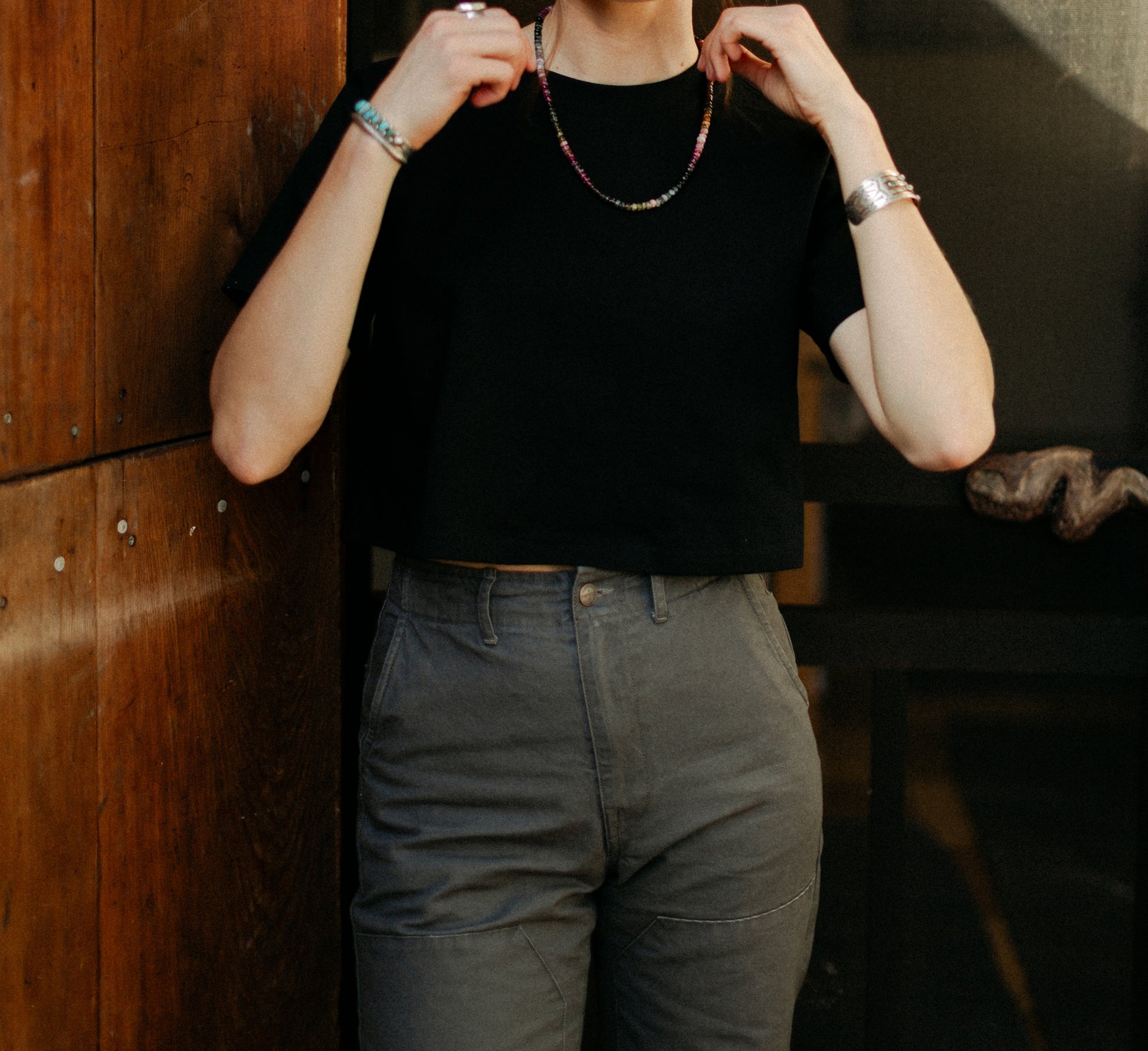 Close-up of the high-waisted Lily Pant in salt wash vintage coal, featuring double-knee reinforcement and durable 100% cotton canvas construction.