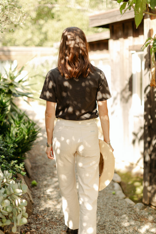 Back view of the high-waisted Lily Pant in softwashed cream, showcasing the straight-leg silhouette and durable 100% cotton canvas construction.