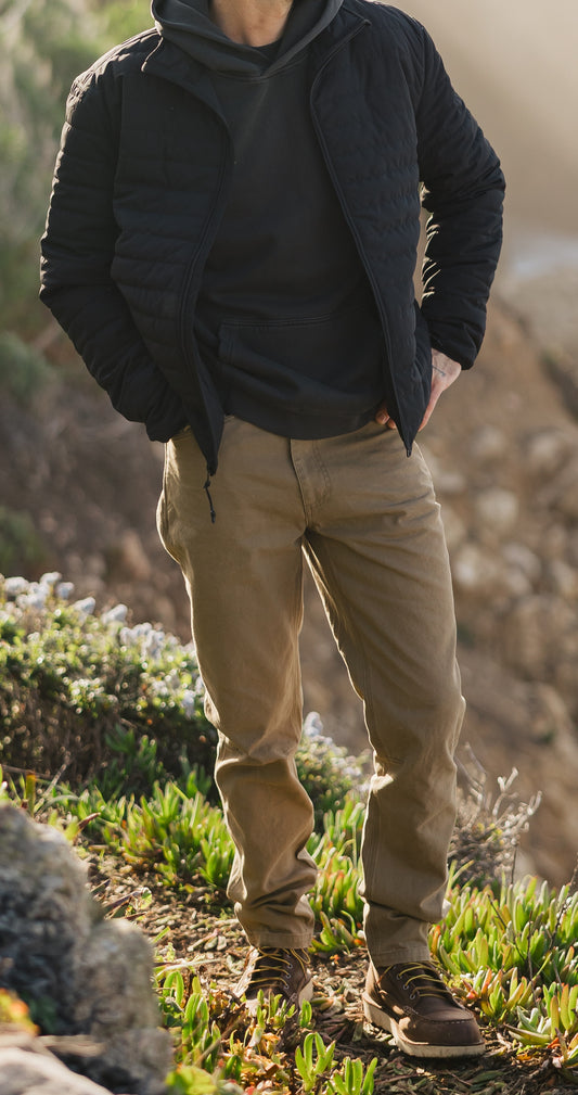 Men’s Tradesman Pant in salt washed Tobacco paired with the black Stillwater Jacket, featuring 100% cotton canvas durability and a rugged coastal workwear silhouette.