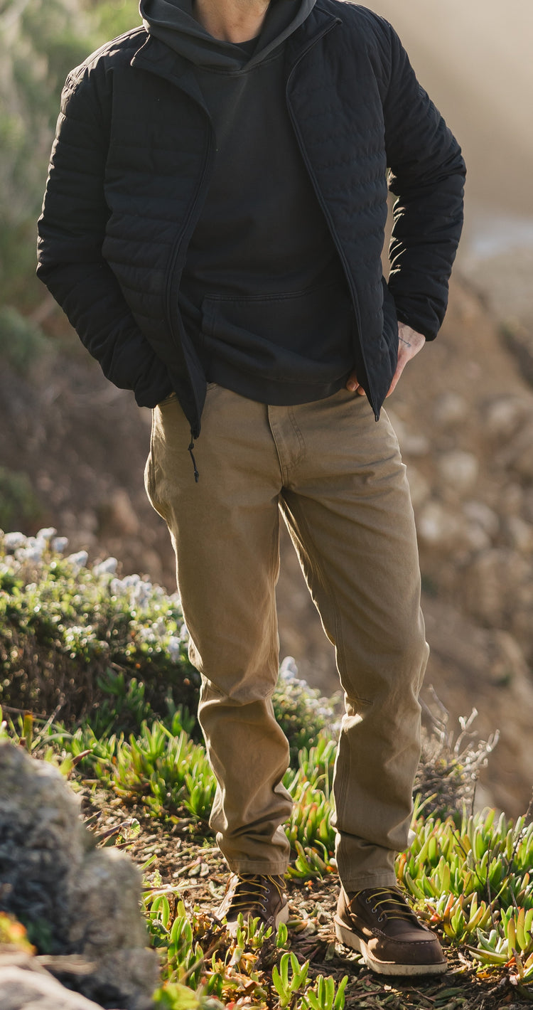Men’s Tradesman Pant in salt washed Tobacco paired with the black Stillwater Jacket, featuring 100% cotton canvas durability and a rugged coastal workwear silhouette.